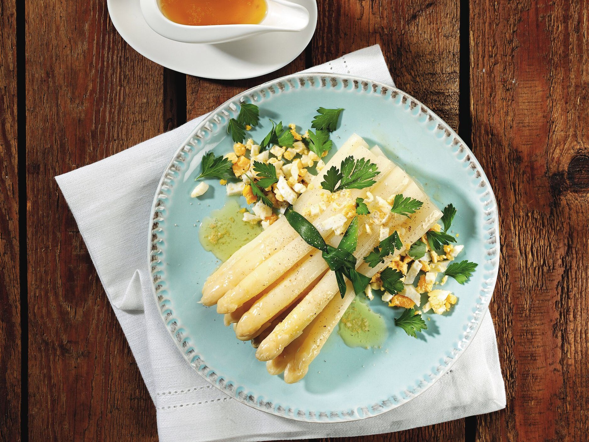 Ein Teller mit frittierten Reisbällchen, Saucen und Zitronen.